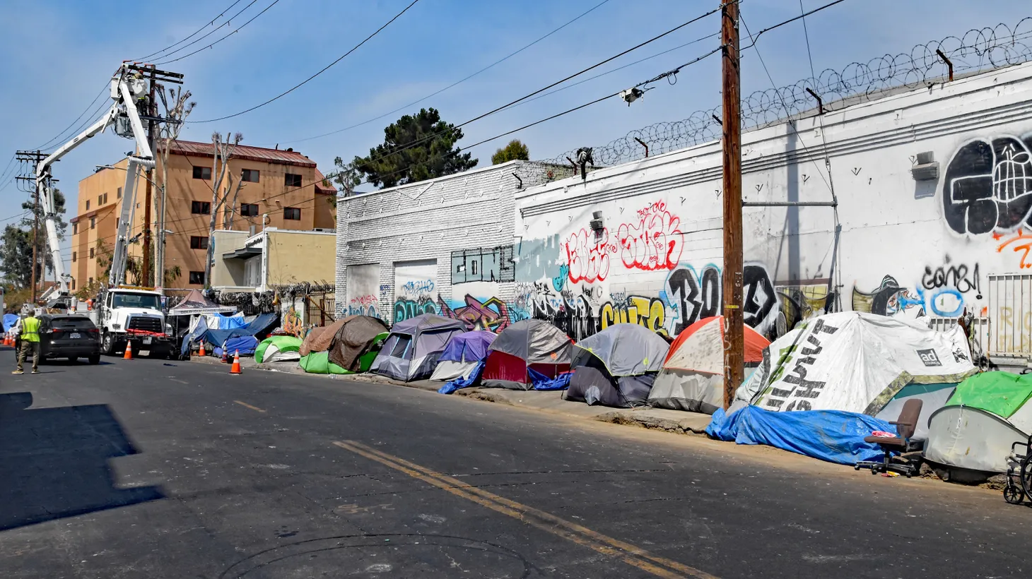 A long line of homeless encampments line a street along downtown LA’s Skid Row, June 15, 2021.
