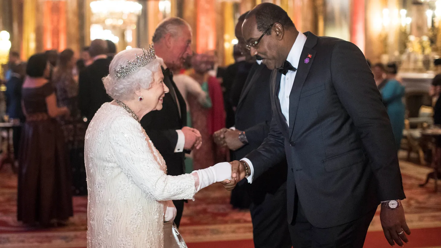Queen Elizabeth II greets Gaston Browne, Prime Minister of Antigua and Barbuda, in the Blue Drawing Room at Buckingham Palace in London as she hosts a dinner during the Commonwealth Heads of Government Meeting on April 19, 2018.