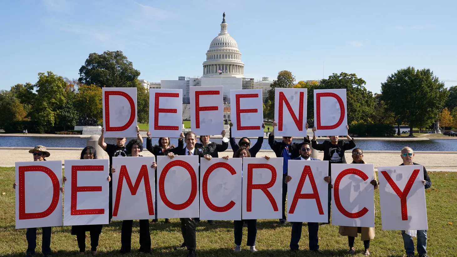 Activists hold up letters spelling “defend democracy” during a rally amid revelations by the Jan. 6 select committee, in front of the U.S. Capitol, in Washington, U.S., October 20, 2022.