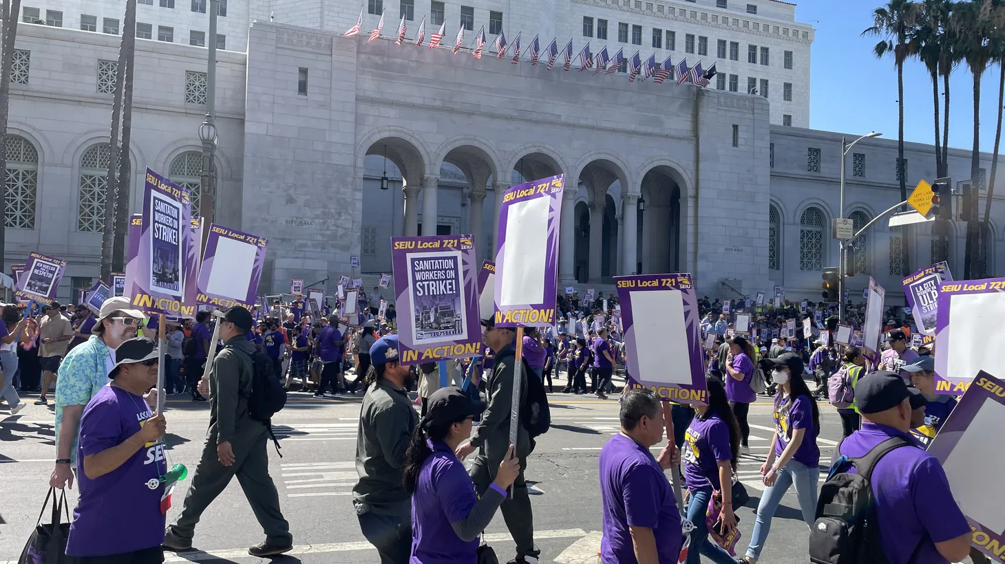 SEIU Local 721 members march with protest signs outside LA City Hall, August 8, 2023.