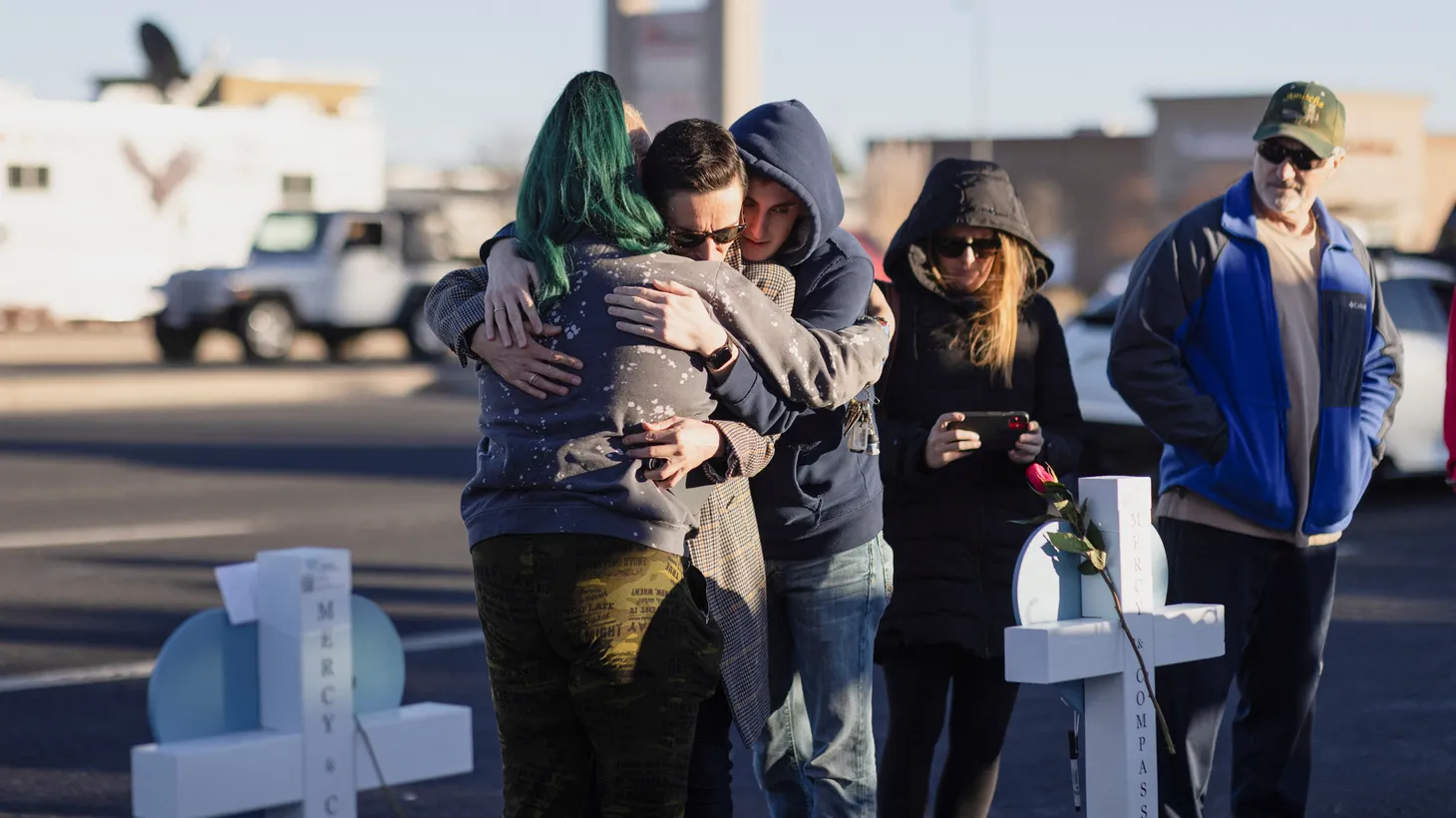 Matthew Ward is embraced by Taylor Sunderman and Alex Gallagher at a memorial for the victims of a mass shooting at LGBTQ nightclub Club Q, in Colorado Springs, Colorado, U.S. November 21, 2022.