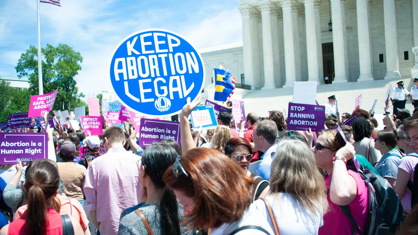 Activists outside the U.S. Supreme Court hold signs advocating for legal abortions, May 21, 2019.