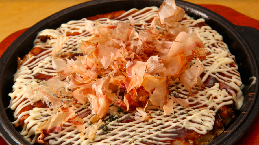 This famed Japanese pancake, called okonomiyaki, has become a canvas of creativity for chefs.