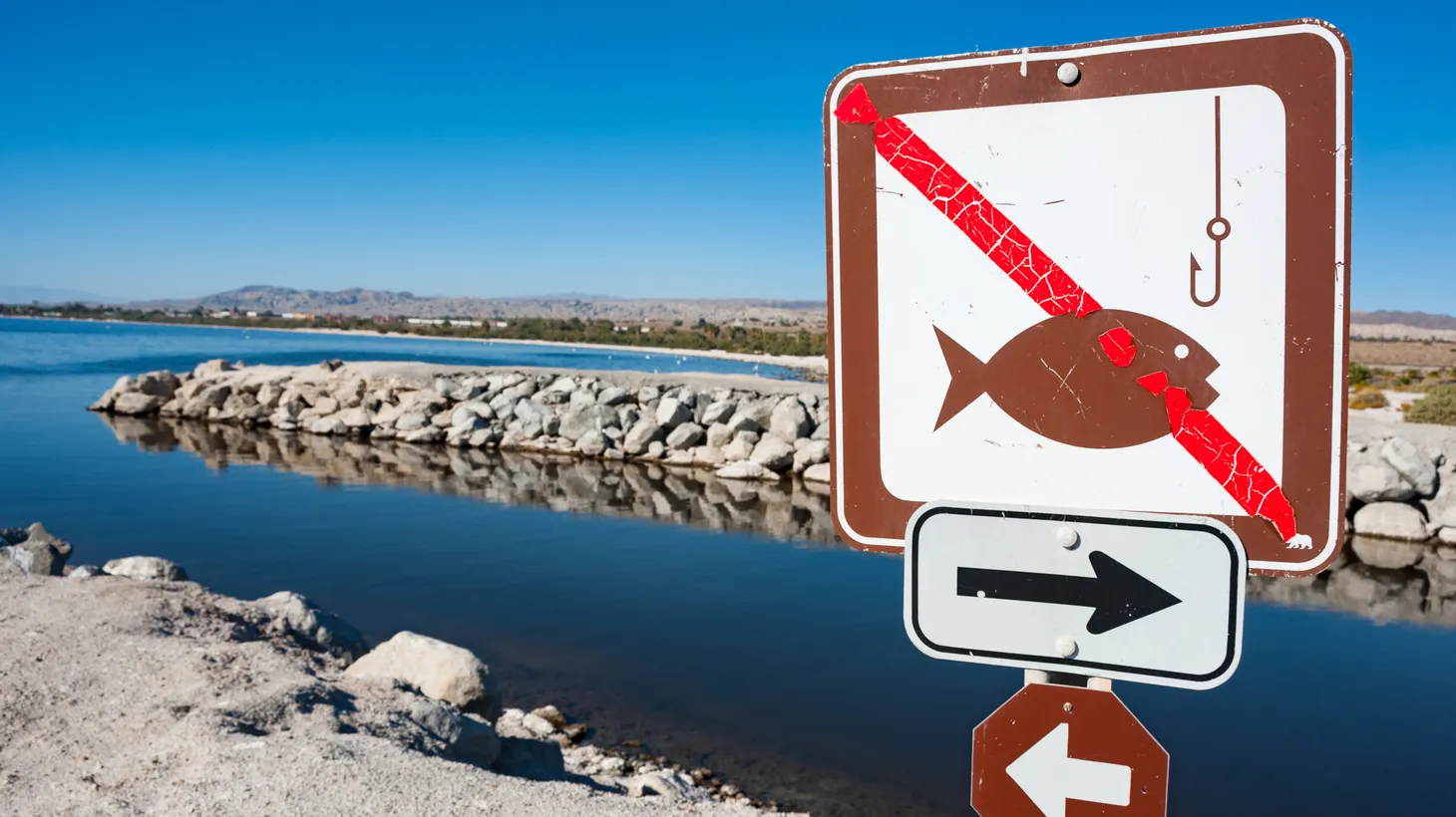 A “no fishing” sign appears on the banks of the Salton Sea in Southern California.