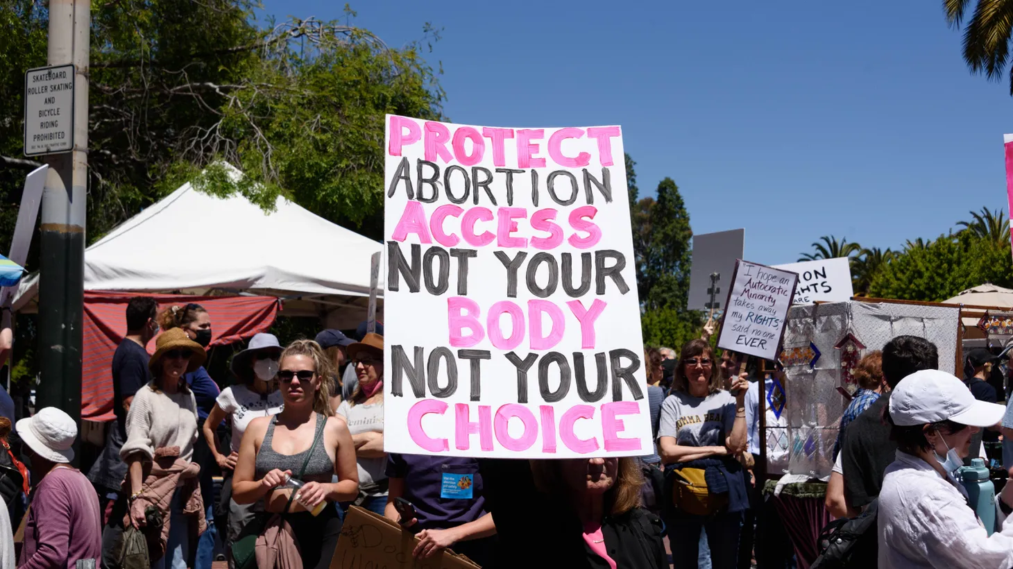 An activist carries a sign that says “protect abortion access, not your body, not your choice,” in San Francisco, California, May 14, 2022.