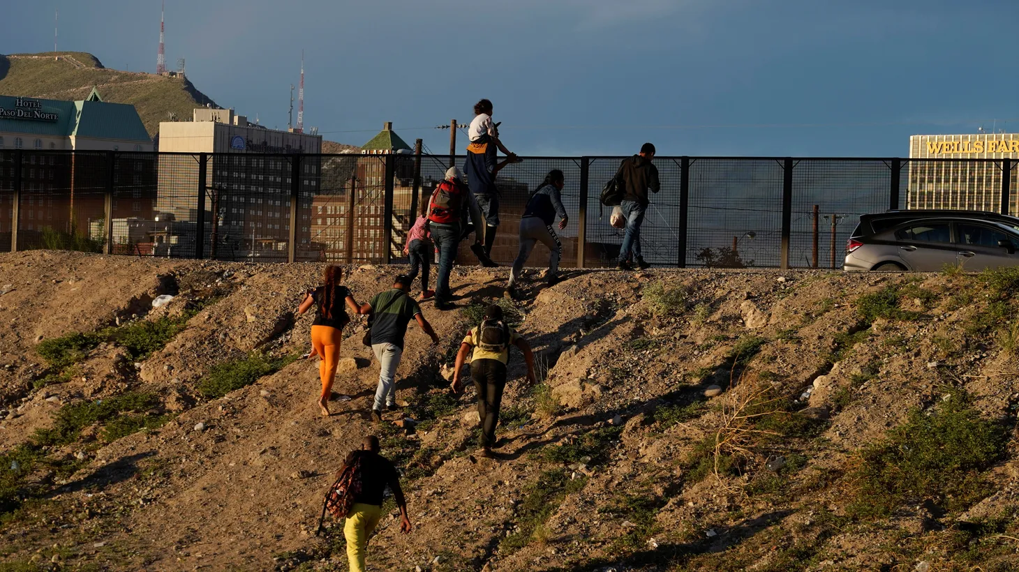 Asylum-seeking migrants, mostly from Venezuela, climb up an embankment after crossing the Rio Grande to El Paso, Texas, U.S. as seen from Ciudad Juarez, Mexico, September 19, 2022.