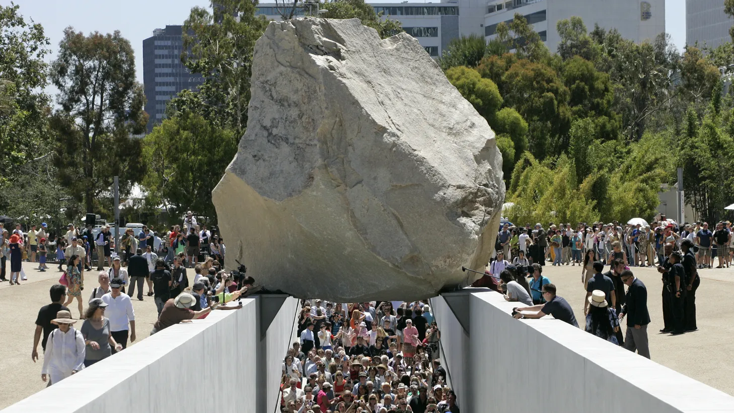 A large crowd walks through ''Levitated Mass,” artist Michael Heizer's 340-ton megalith rock at the Los Angeles County Museum of Art in California, June 24, 2012.