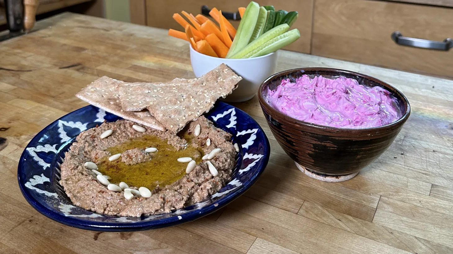 Garlicky beet labne (right), with its bright fuschia, is topped with garlic and a squeeze of lemon. Muhammara (left) is a Syrian mixture of roasted peppers pureed with walnuts and wheat crackers.