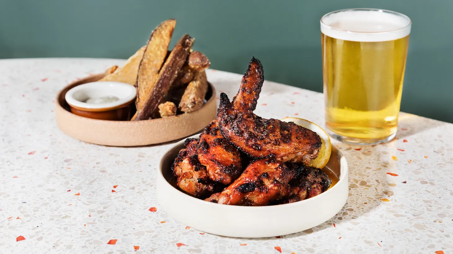 At Eszett, you can order their charcoal-grilled chicken wings with salsa macha, and big fries served with garlic mayo. Highland Park Brewery offers “Hello LA” IPA.
