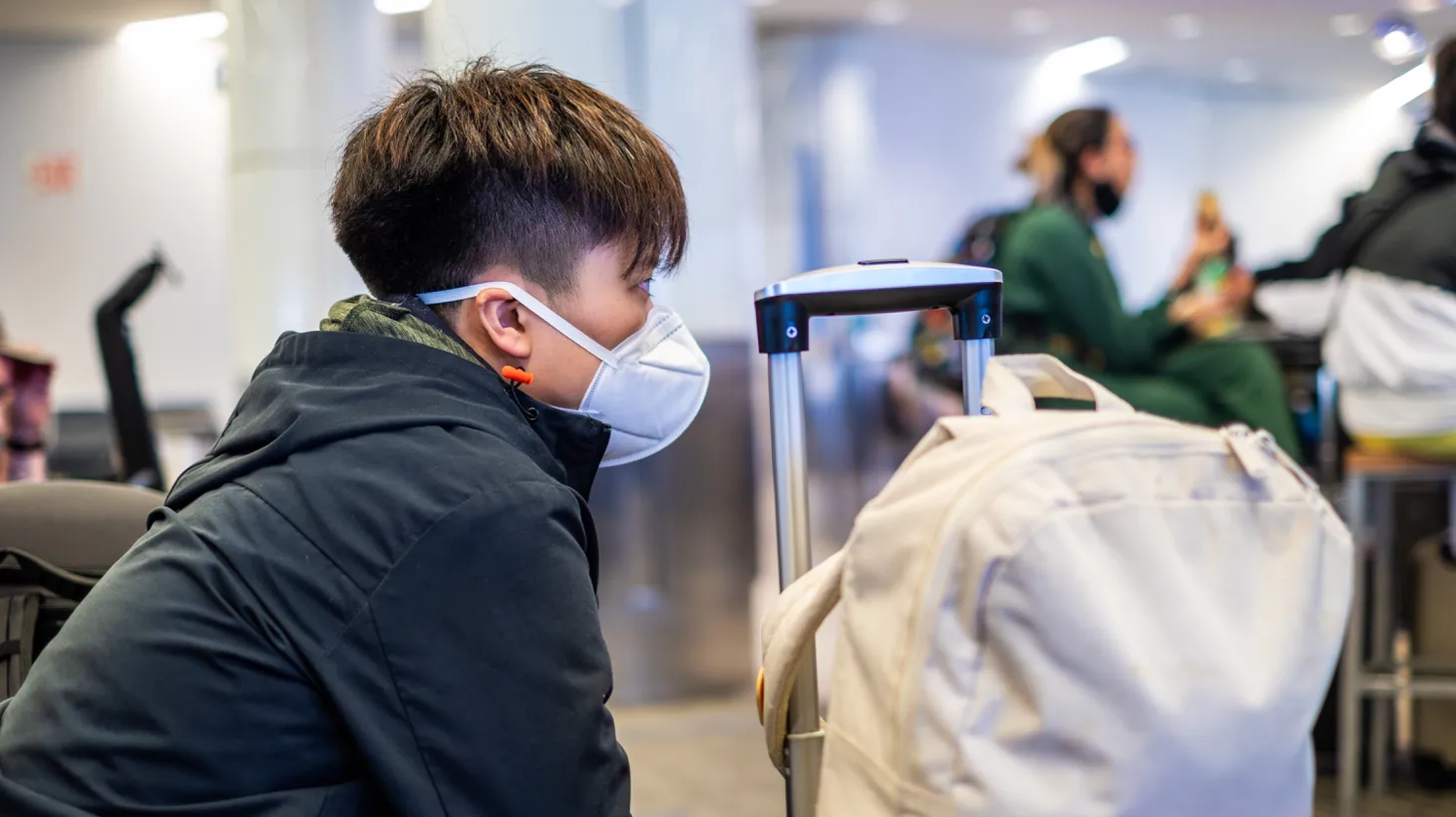 A man wears a K-N95 mask at LAX airport, May 22, 2022. The U.S. health care system is not optimally prepared to handle long COVID, and people should protect themselves by wearing masks and reducing time in places where a lot of viruses could be around, says Ziyad Al-Aly, clinical epidemiologist at Washington University.