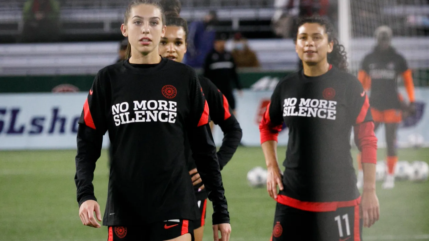 The Portland Thorns' warm-up shirts say "No More Silence." The Houston Dash narrowly defeated the Thorns 3-2 on October 6, 2021 at Providence Park in Portland, Oregon. This was the first Thorns match after the temporary hiatus in National Women’s Soccer when the Paul Riley sexual harassment scandal broke.
