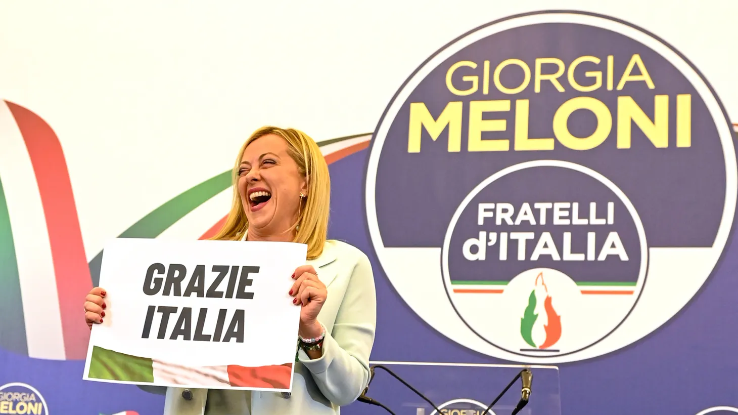 Giorgia Meloni, leader of the far-right party Brothers of Italy, holds a sign thanking voters in the Italian general election in Rome, Italy on Sept. 26, 2022.