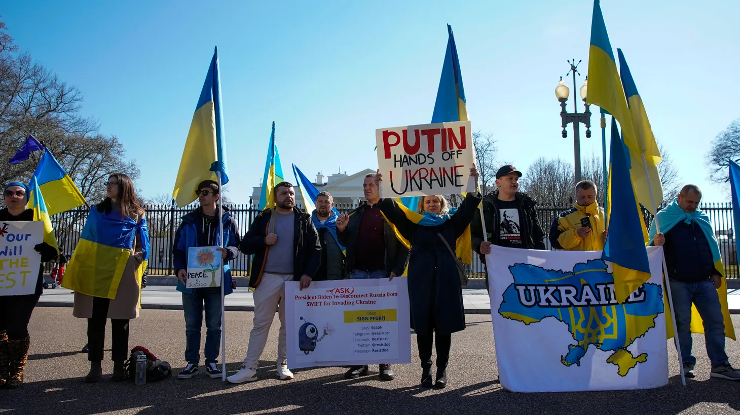 Demonstrators hold Ukrainian flags, signs and banners during a "Stand with Ukraine" rally against the Russian invasion of Ukraine, in front of the White House in Washington, U.S., February 28, 2022.