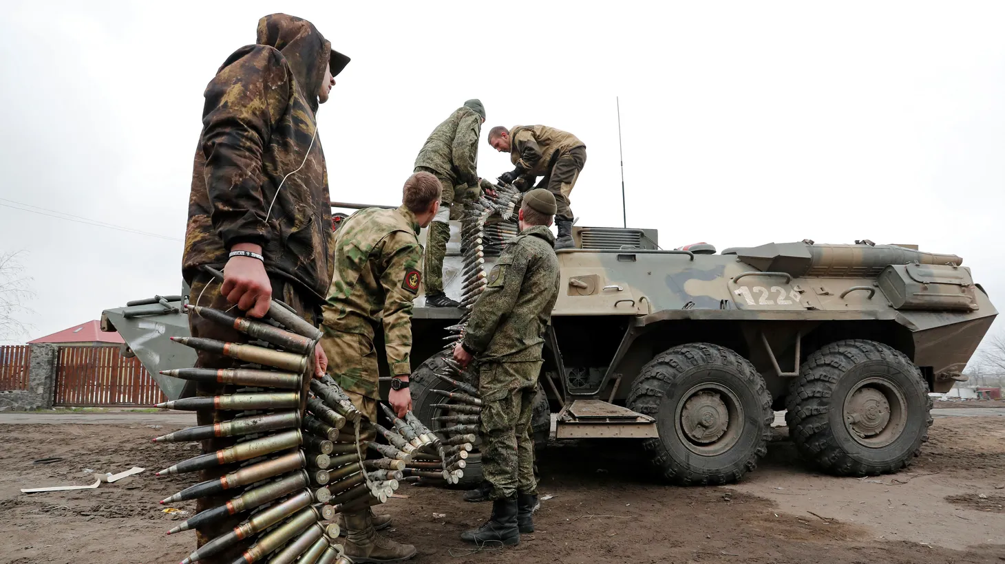 Service members of pro-Russian troops load ammunition into an armored personnel carrier during fighting in Ukraine-Russia conflict in the southern port city of Mariupol, Ukraine April 12, 2022.