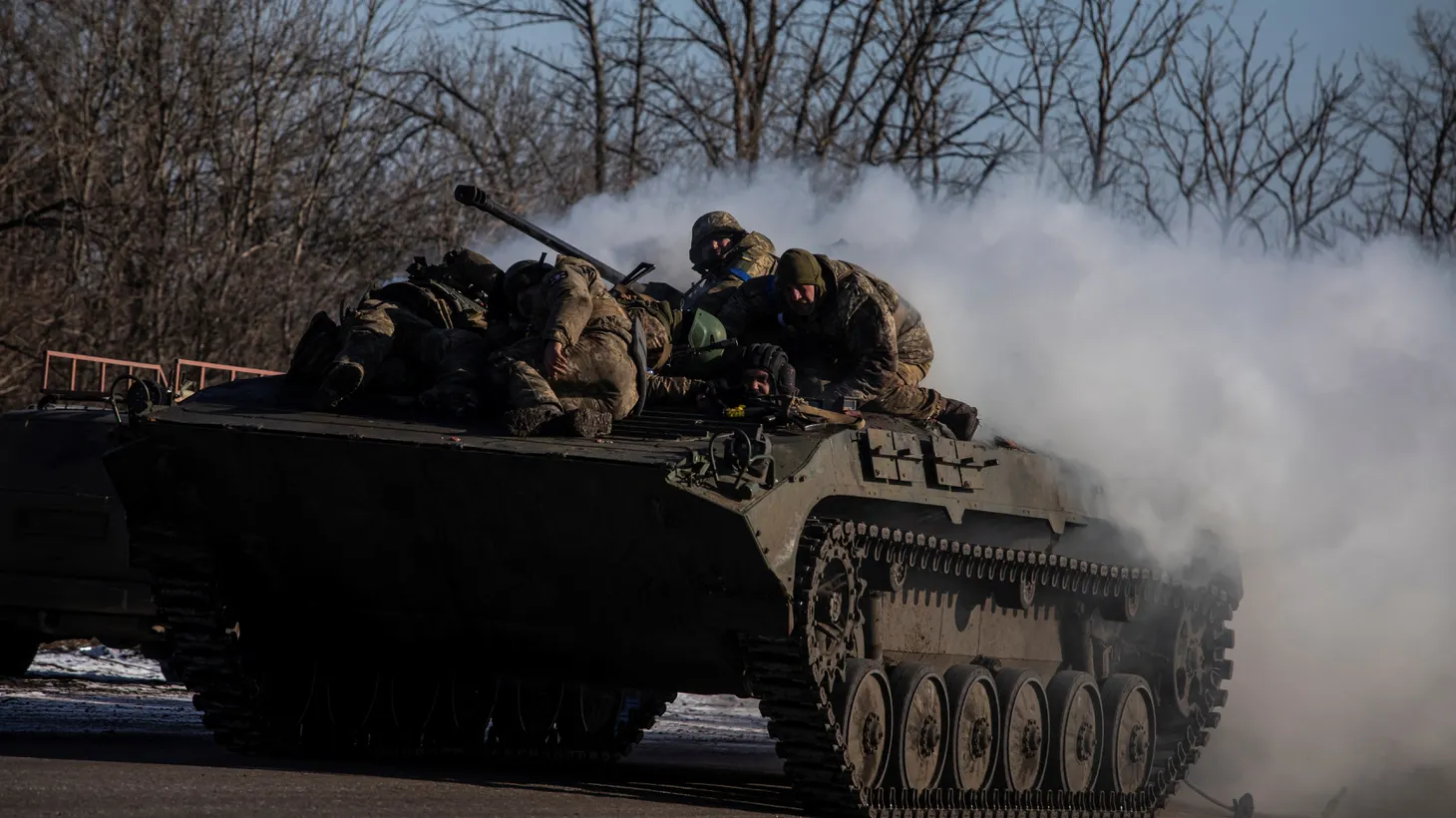 Ukrainian service members ride atop a BMP-2 infantry fighting vehicle near a frontline, amid Russia's attack on Ukraine, in Donetsk region, Ukraine, February 8, 2023.