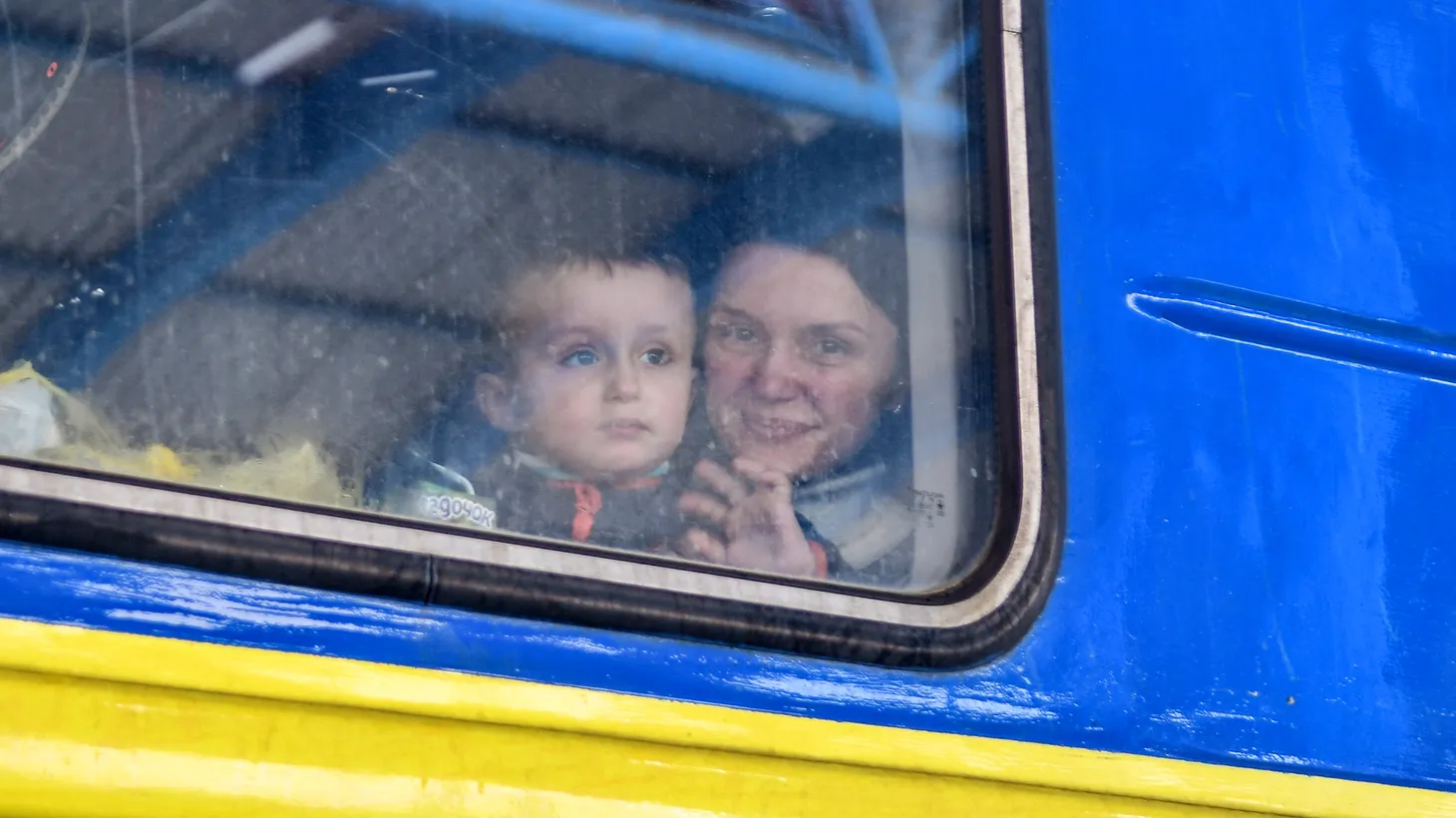 A woman with a boy is seen on the evacuation train, Zaporizhzhia, southeastern Ukraine on March 7, 2022.