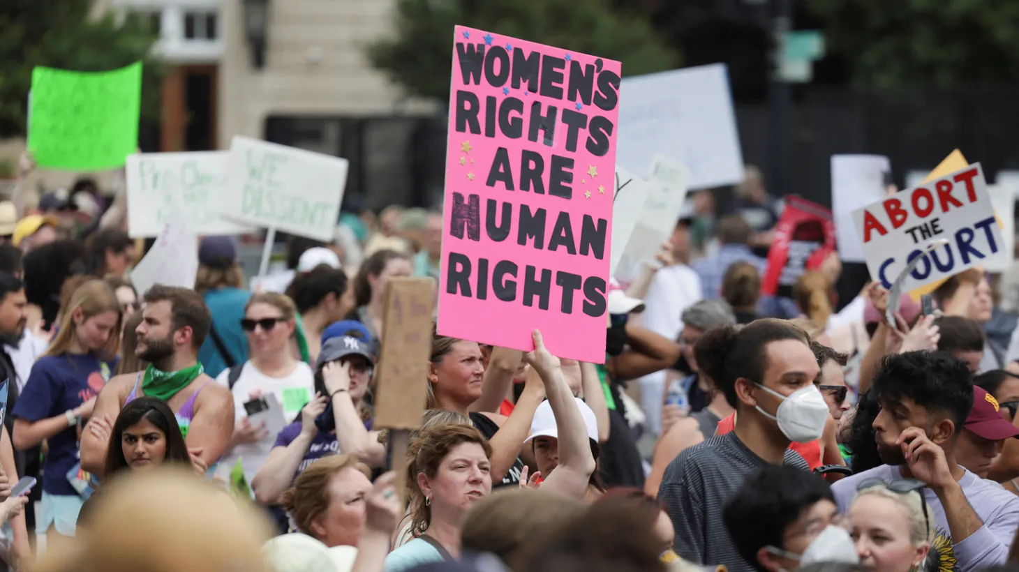Activists hold signs that say, “Women’s rights are human rights” and “abort the court,” outside the U.S. Supreme Court as the justices overturn the landmark Roe v. Wade abortion decision in Washington, U.S., June 24, 2022.