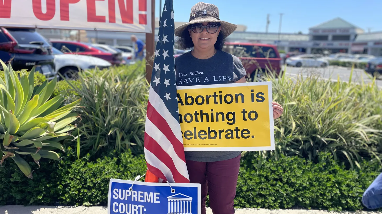 Glendy Perez of Hacienda Heights celebrates the end of Roe v. Wade outside an El Monte shopping center where there is a Planned Parenthood. She’s been coming to this location since 2017 with other pro-life advocates.