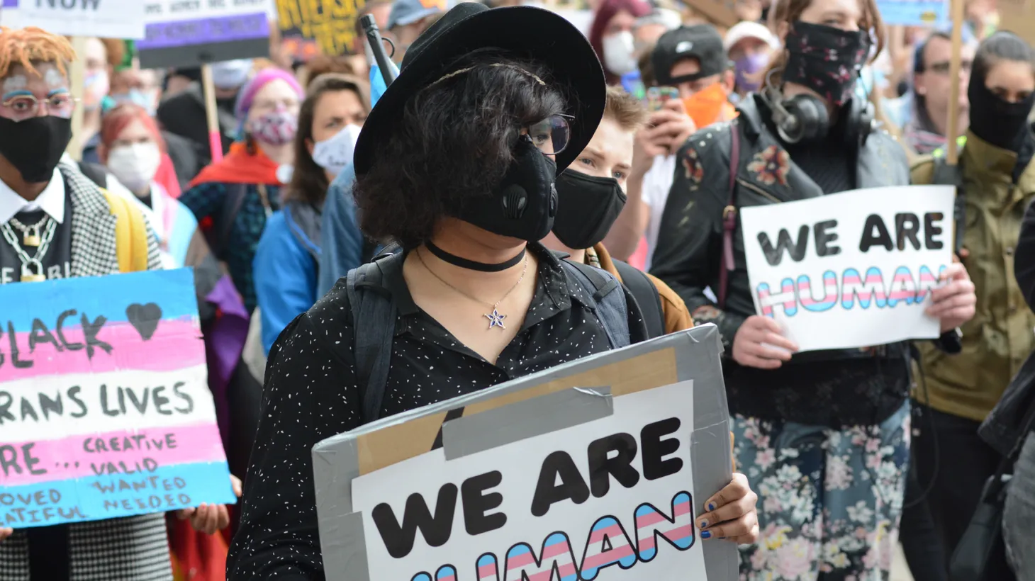 Activists at a transgender rally hold signs that say, “We are human.”