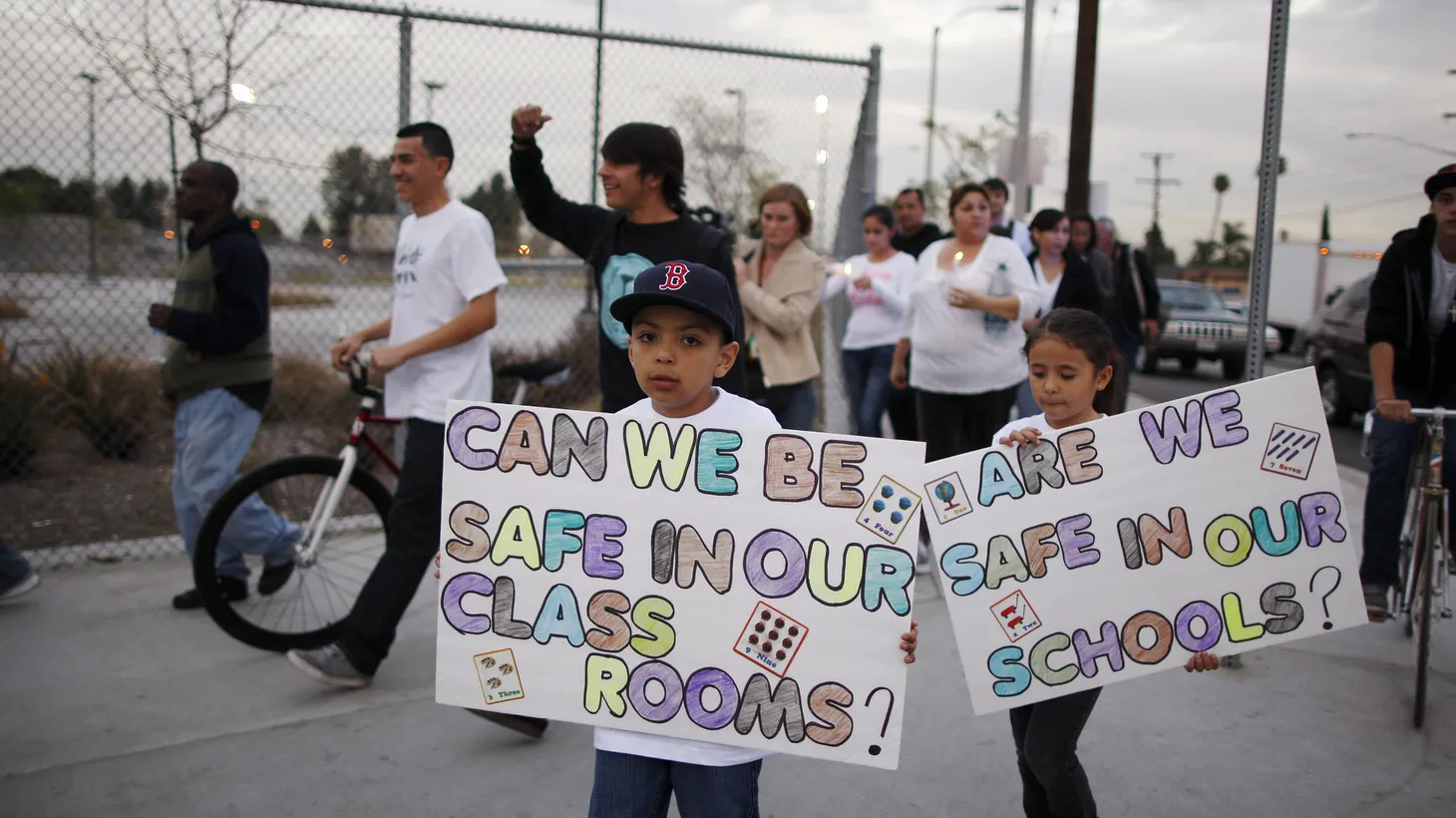 During a march among parents and students of LAUSD’s Miramonte Elementary School, children carry signs that say, “Can we be safe in our classrooms?” and “Are we safe in our schools?”