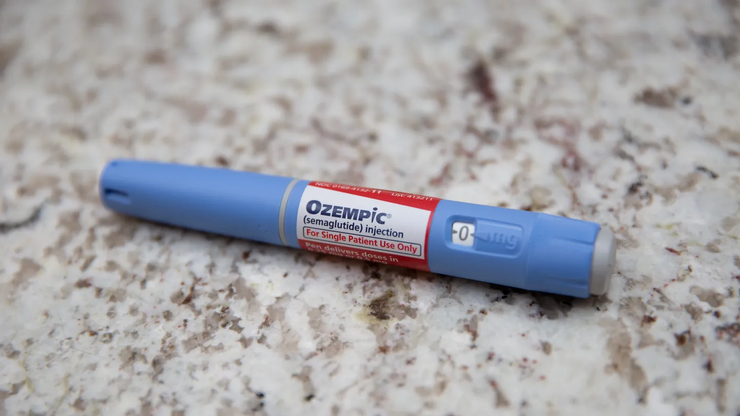 A photo illustration of an Ozempic pen sits on a table in Carmel, IN, Jan. 26, 2023. The diabetes drug Ozempic has seen supply chain issues due to off-label prescribing for weight loss.