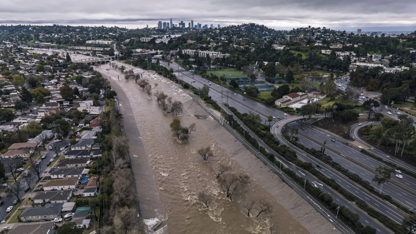 A drone view shows the Los Angeles River swollen with rainwater, February 26, 2023.
