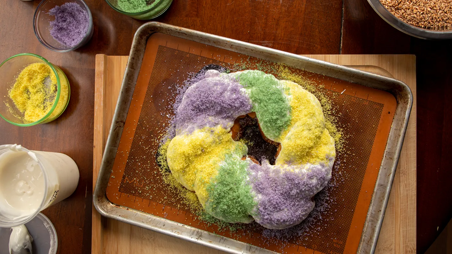 This king cake from Compagnon Bakery in New Orleans is topped with the traditional sugar decoration in the Mardi Gras triad of purple, green and gold.