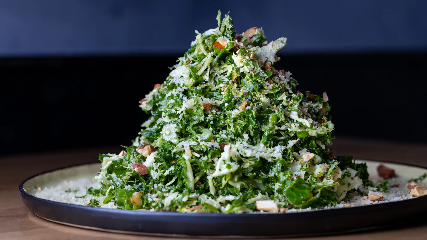This kale salad features parmigiano, avocado, cilantro, fresh herbs, and sweet-spicy almond vinaigrette from Jame Enoteca in El Segundo.
