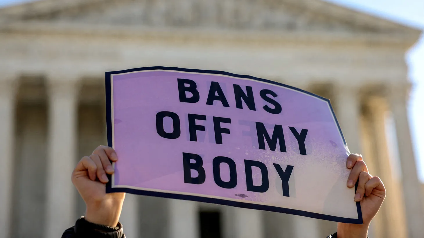 A pro-choice demonstrator holds a sign outside the United States Supreme Court as the court hears arguments over a challenge to a Texas law that bans abortion after six weeks in Washington, U.S., November 1, 2021.