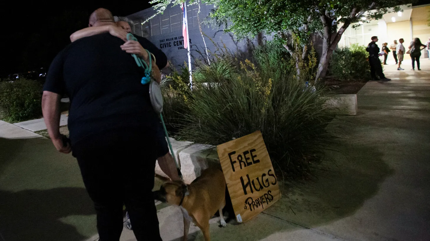 Jennifer Click of Bandera, Texas, offers hugs to people as they leave the Civic Center after a mass shooting at Robb Elementary School in Uvalde, Texas, U.S., May 24, 2022.