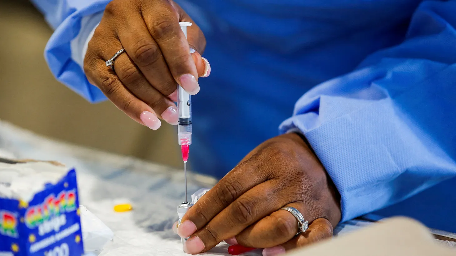 A health worker prepares a monkeypox vaccine at a drive-through vaccination point at the Westchester Medical Center in Valhalla, New York, U.S., July 28, 2022.