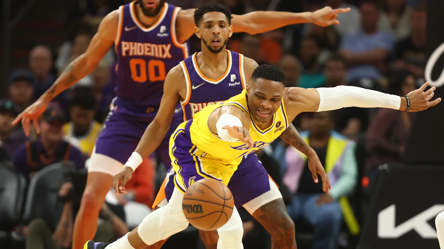 Los Angeles Lakers guard Russell Westbrook (0) battles for a loose ball against the Phoenix Suns in the first half at Footprint Center, Apr. 5, 2022.