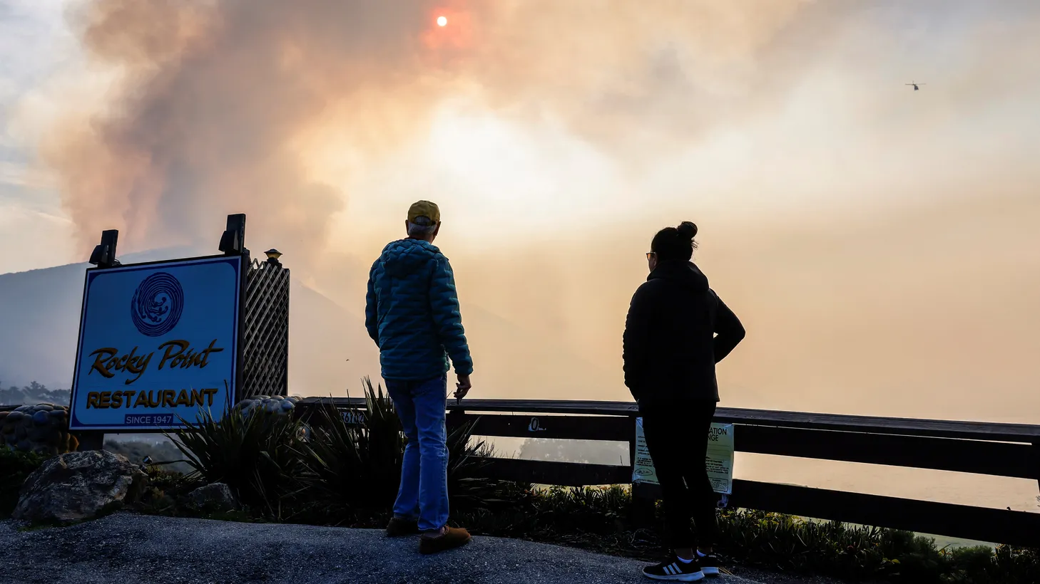 Local residents watch from Rocky Point as the Colorado Fire burns near Big Sur, California, January 22, 2022.