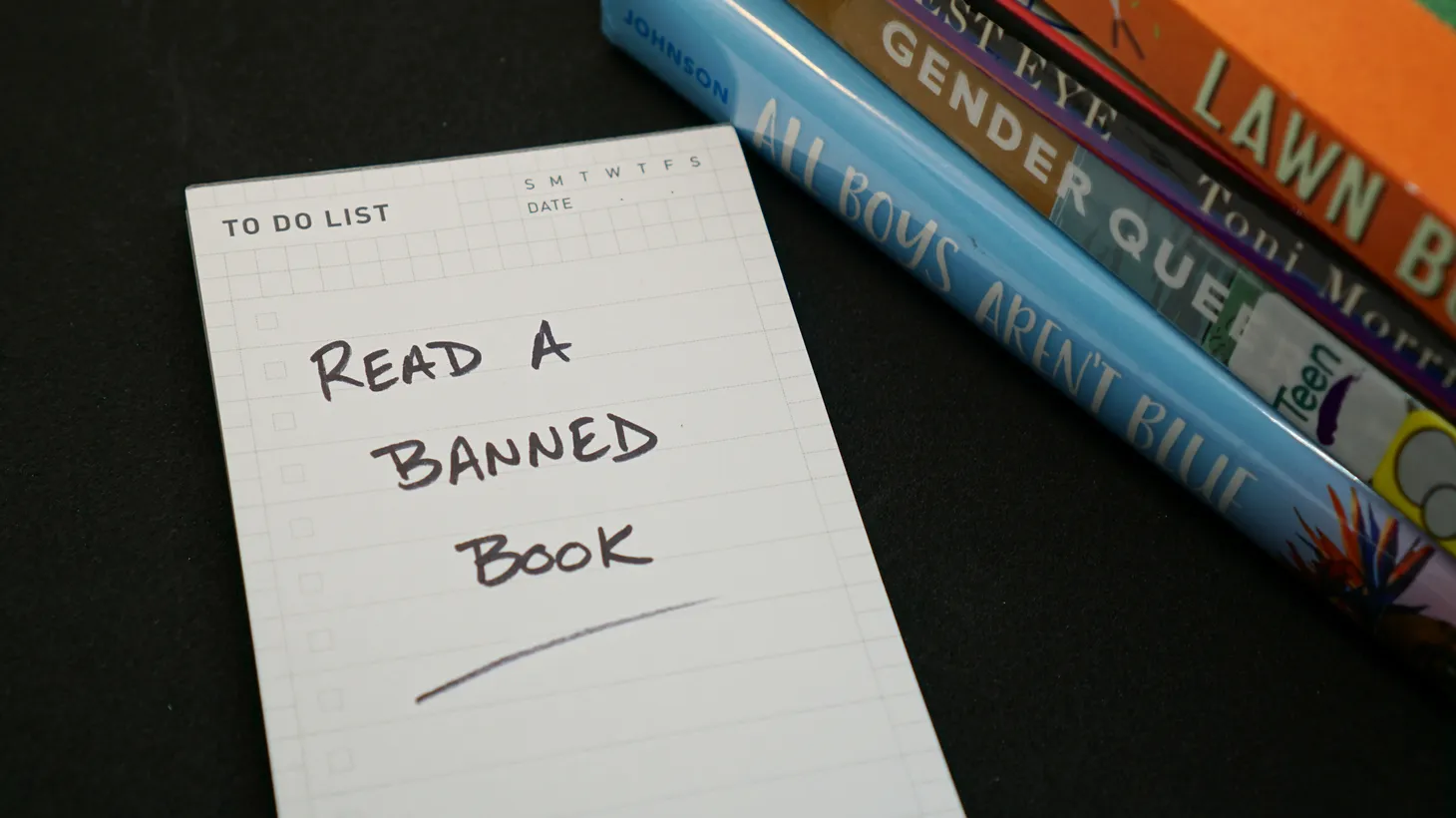 A to-do list says “read a banned book.” Dave Eggers says, “How do you ban a book? They took it off all of the shelves in the classroom, they took them out of libraries. … So that's a book ban when you make it unavailable to all students. … These are going on all over the country, and it's very similar playbook.”